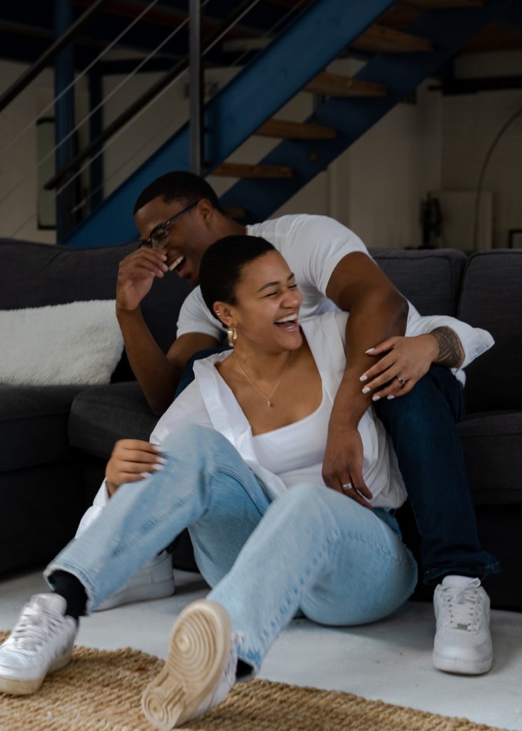 Couple embracing and laughing on a couch